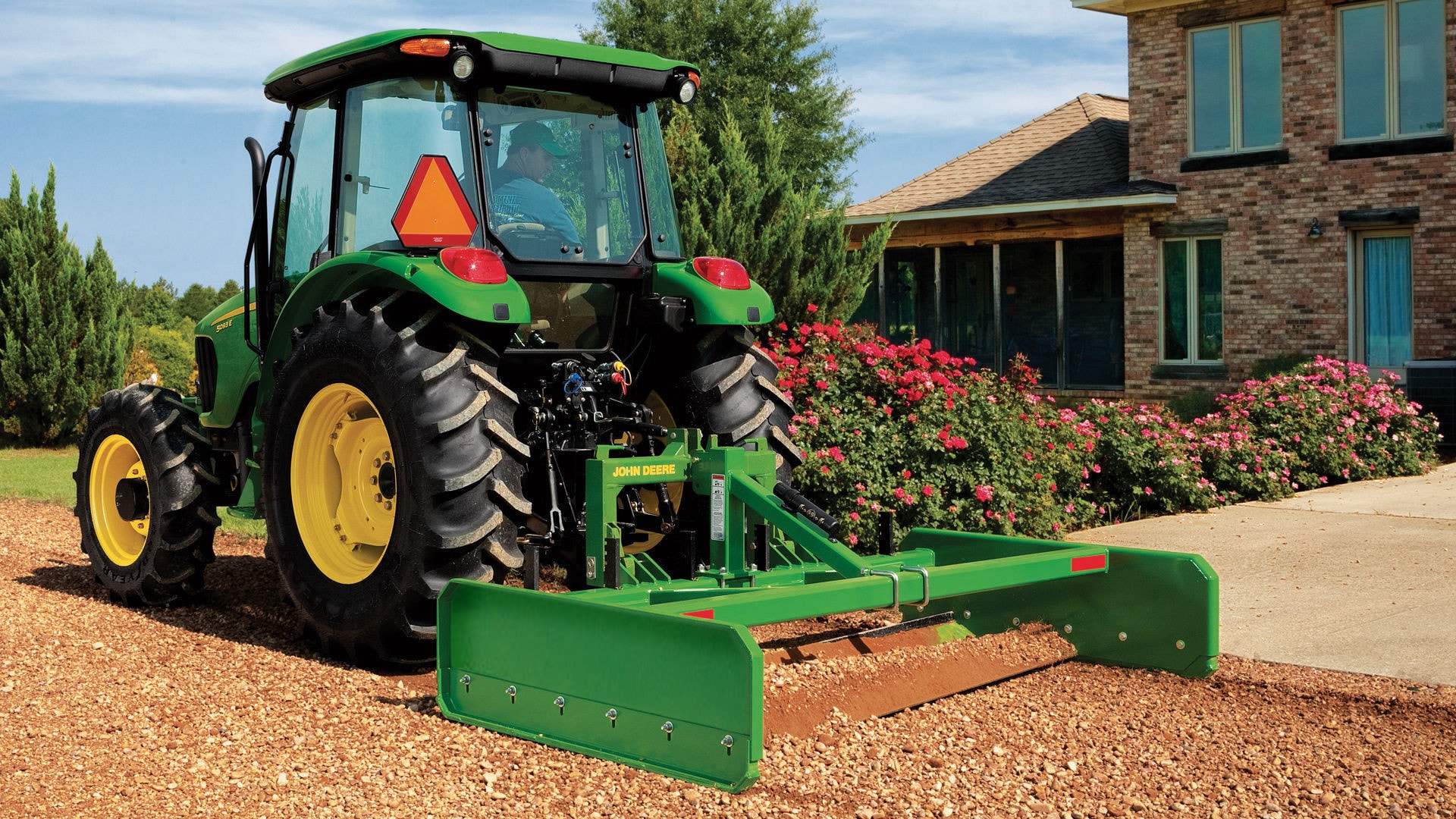 image of tractor with attachment in dirt