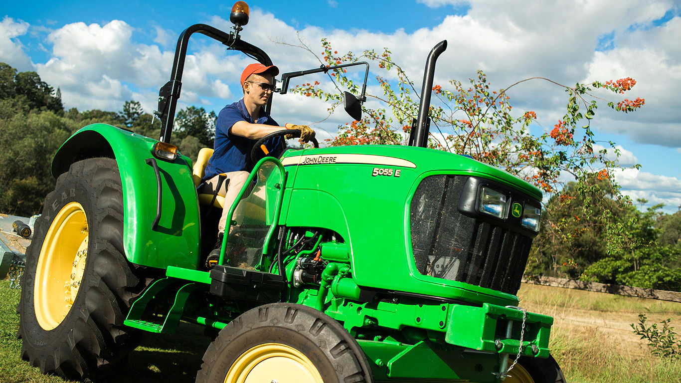 A farmer driving his tractor on the farm